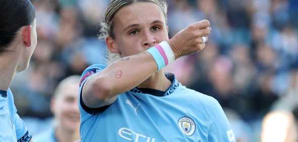Kerstin Casparij of Manchester City kisses her wrist as she celebrates scoring her team's first goal during the Barclays Women's Super League match between Manchester City FC and Everton FC at Joie Stadium.