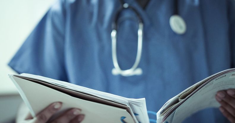 A doctor looking at two files.
