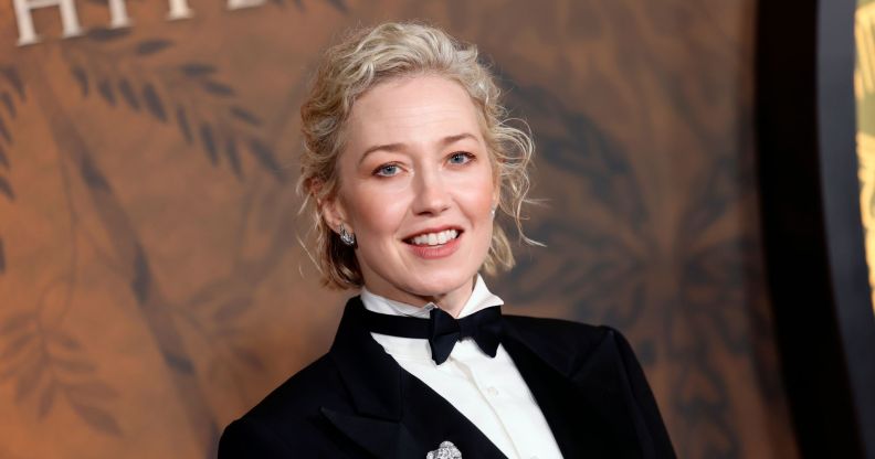 Carrie Coon at the White Lotus premiere in a suit and bow tie against a brown backdrop.