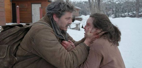 Pedro Pascal as Joel and Bella Ramsey as Ellie in The Last of Us. Joel is clutching Ellie's face which is bleeding. They both look in shock.