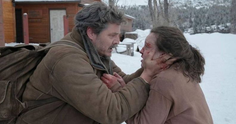 Pedro Pascal as Joel and Bella Ramsey as Ellie in The Last of Us. Joel is clutching Ellie's face which is bleeding. They both look in shock.