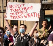 Protester holds up sign reading "Respect trans pride or expect trans wrath"