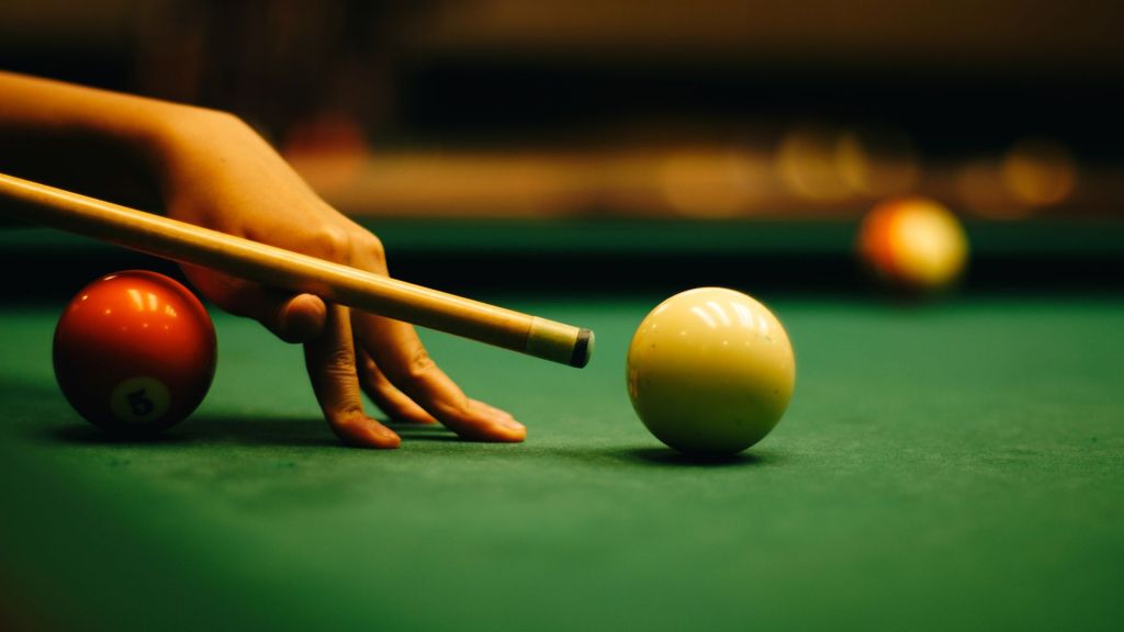 Stock image of a woman playing pool