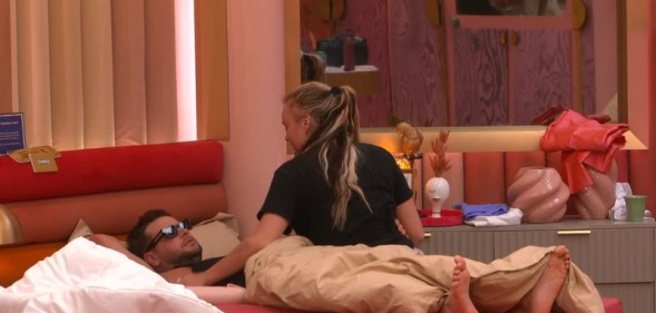 JoJo Siwa pictured sitting on a bed with Chris Hughes