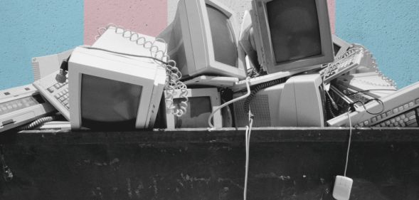 A pile of computer parts in a skip.