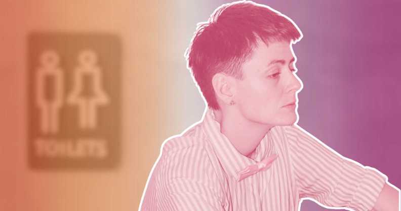 A lesbian woman in front of a blurry toilet sign