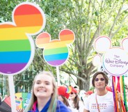 Orlando, Florida. October 15, 2022. Woman with a sign and Group of members of the LGBTIQIA+ And Allied Employees of The Walt Disney Company in the Come Out With Pride Orlando parade on the E Central Blvd street.