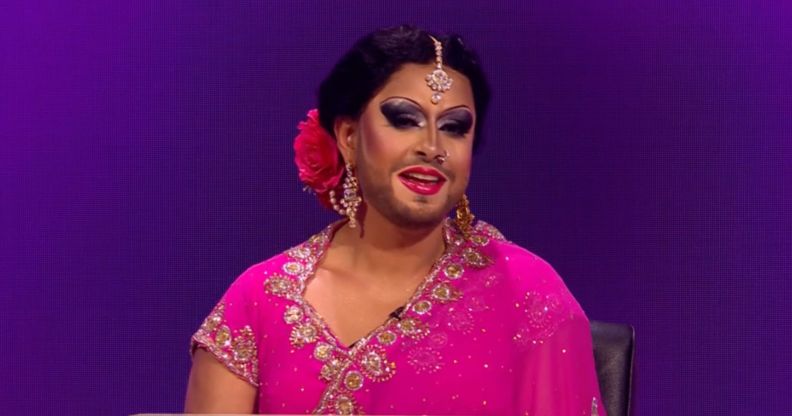 Amir Dean as Lady Bushra in a pink dress and full drag as a contestant on Blankety Blank.