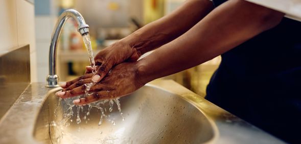 A person washing their hands.