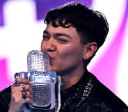 Eurovision winner JJ kisses the glass trophy on stage at the grand finale.