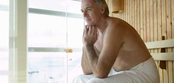 Man sitting in sauna.