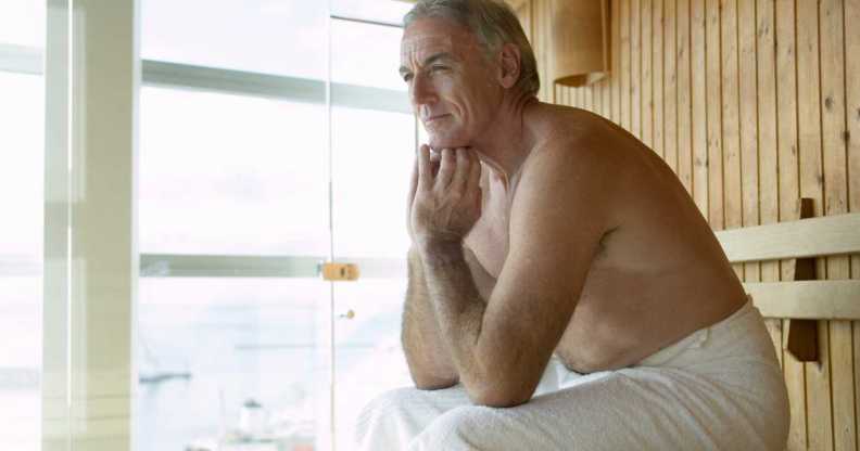 Man sitting in sauna.
