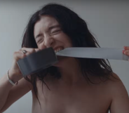 Lorde binds her chest in the music video for 'Man of the Year'