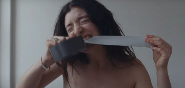Lorde binds her chest in the music video for 'Man of the Year'