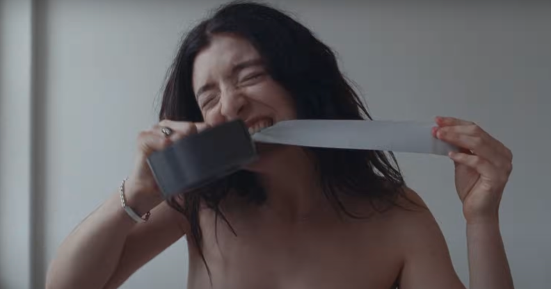 Lorde binds her chest in the music video for 'Man of the Year'