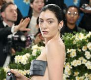 Lorde poses in a strapless silver top at the Met Gala.