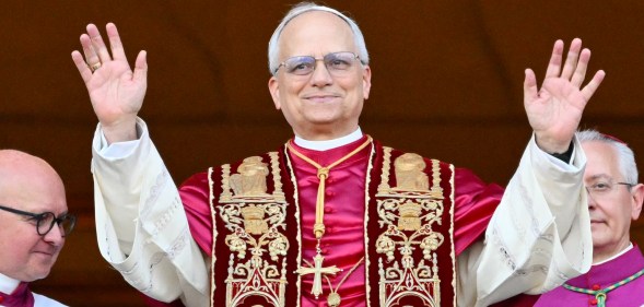 Newly elected Pope Leo XIV, Robert Prevost arrives on the main central loggia balcony of the St Peter's Basilica for the first time, after the cardinals ended the conclave, in The Vatican, on May 8, 2025. Robert Francis Prevost was on Thursday elected the first pope from the United States, the Vatican announced. A moderate who was close to Pope Francis and spent years as a missionary in Peru, he becomes the Catholic Church's 267th pontiff, taking the papal name Leo XIV. (Photo by Alberto PIZZOLI / AFP)