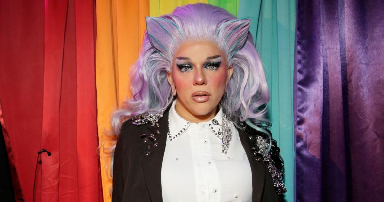 Aja attends as RuPaul's Drag Race All Stars 10 visit the Stonewall Inn NYC on May 06, 2025 in New York City. She is wearing a violet wig with horns, a white shirt and dark blazer.