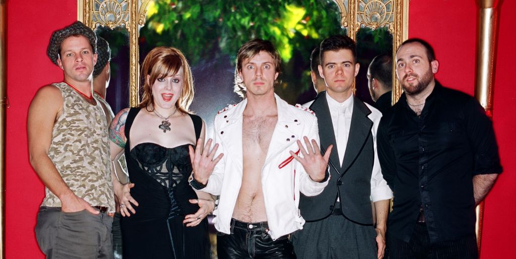 Scissor Sisters as a fivesome in 2004: Paddy Boom, Ana Matronic, Jake Shears, Del Marquis, and Babydaddy. 