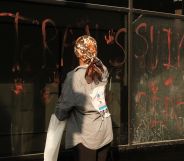 An activist leaving handprints on the windows of the NHS HQ in Waterloo Road, London.