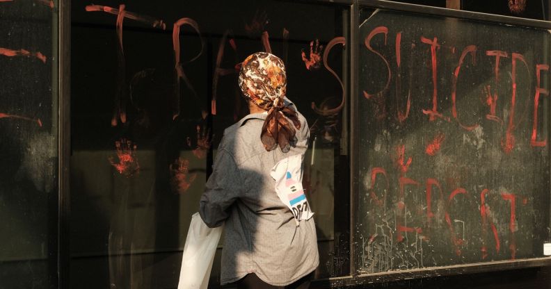 An activist leaving handprints on the windows of the NHS HQ in Waterloo Road, London.