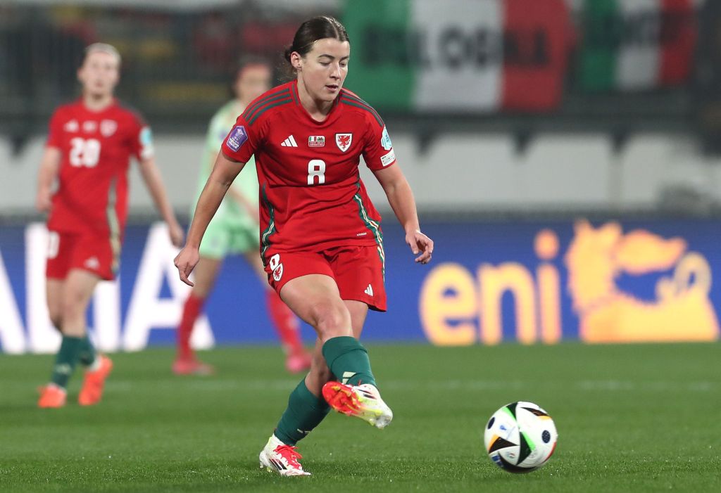 Angharad James of Wales in action during the UEFA Women's Nations League. She's in an all-red kit with green socks.