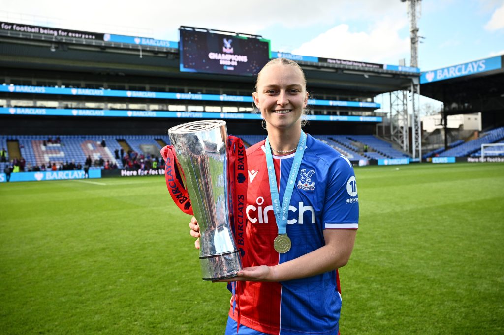 Elise Hughes of Crystal Palace poses for a picture with a trophy after confirming their promotion to the Super League and during the Barclays Women's Championship