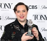 Jak Malone with his Tony Award. Wearing an embazzled black blazer