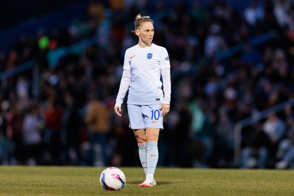 Jess Fishlock in an all-white kit preparing to take a free-kick
