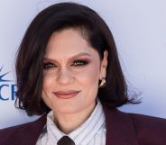 Jessie J on the BAFTA red carpet in 2025 wearing a pin-striped shirt, tie and burgundy blazer.