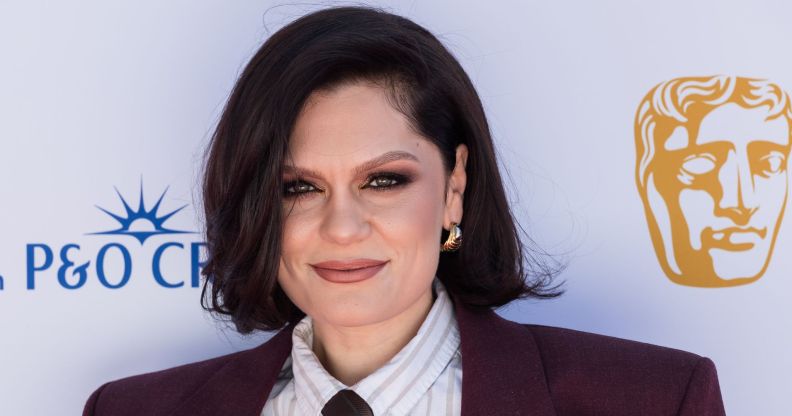 Jessie J on the BAFTA red carpet in 2025 wearing a pin-striped shirt, tie and burgundy blazer.