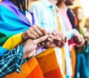 A group of LGBTQ+ teens holding hands.