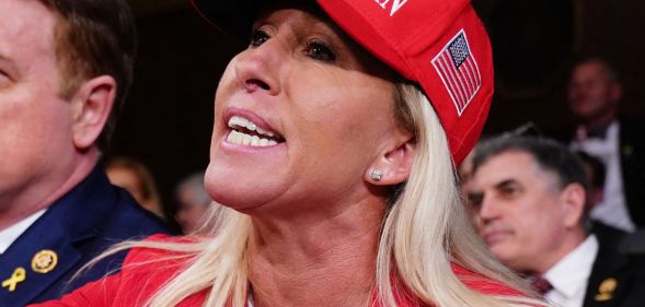 Marjorie Taylor Greene, pictured wearing a MAGA hat.