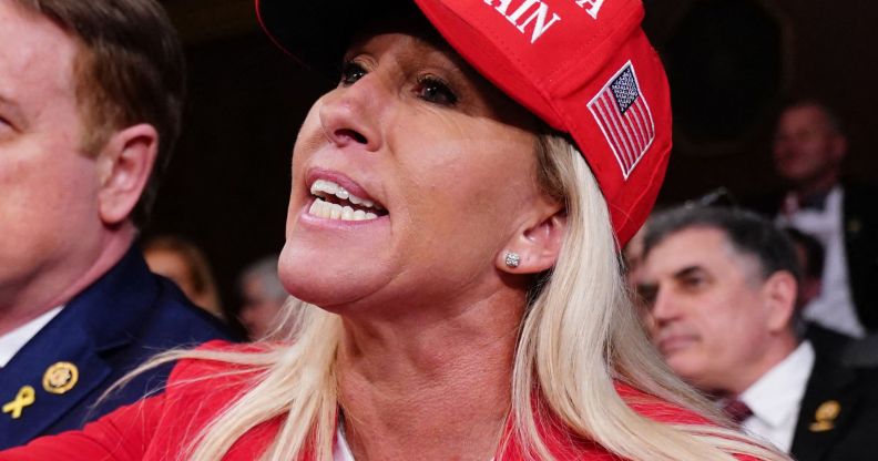 Marjorie Taylor Greene, pictured wearing a MAGA hat.