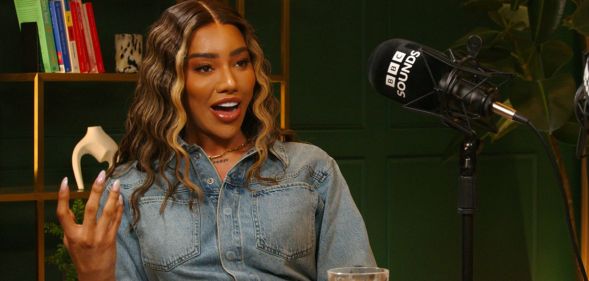 Model and activist Munroe Bergdorf sits by a microphone for a BBC Sounds interview