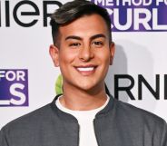 TOWIE star Junaid Ahmed smiles on the red carpet in April 2025.