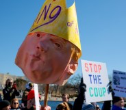 WASHINGTON, DC - FEBRUARY 17: (EDITORS NOTE: Image contains profanity.) The Dome of the U.S. Capitol Building is visible as protesters rally against the Trump administration at the Capitol Reflecting Pool on February 17, 2025 in Washington, DC. Protests are being held in cities across the nation on Presidents' Day against what the organizers say are "the anti-democratic and illegal actions of the Trump administration." (Photo by Kayla Bartkowski/Getty Images)