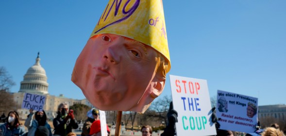 WASHINGTON, DC - FEBRUARY 17: (EDITORS NOTE: Image contains profanity.) The Dome of the U.S. Capitol Building is visible as protesters rally against the Trump administration at the Capitol Reflecting Pool on February 17, 2025 in Washington, DC. Protests are being held in cities across the nation on Presidents' Day against what the organizers say are "the anti-democratic and illegal actions of the Trump administration." (Photo by Kayla Bartkowski/Getty Images)