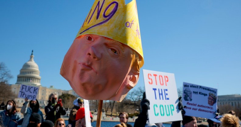 WASHINGTON, DC - FEBRUARY 17: (EDITORS NOTE: Image contains profanity.) The Dome of the U.S. Capitol Building is visible as protesters rally against the Trump administration at the Capitol Reflecting Pool on February 17, 2025 in Washington, DC. Protests are being held in cities across the nation on Presidents' Day against what the organizers say are "the anti-democratic and illegal actions of the Trump administration." (Photo by Kayla Bartkowski/Getty Images)