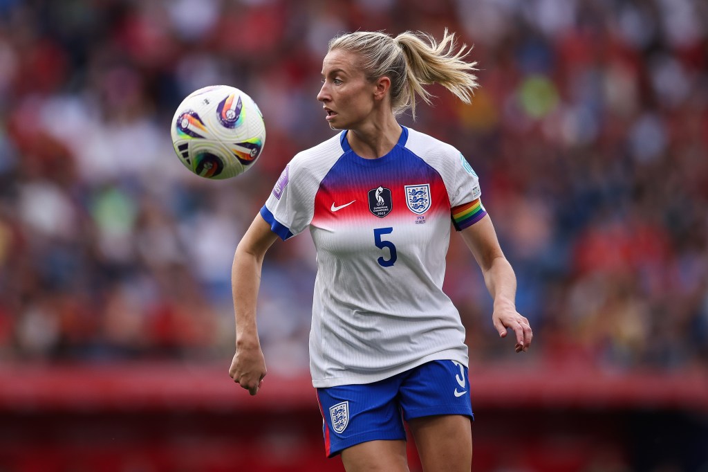 Leah Williamson of England controls the ball during the UEFA Women's Nations League. she's wearing the england kit with a rainbow armnband