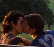 Conan Gray and Corey Fogelmanis kissing in "This Song" music video.