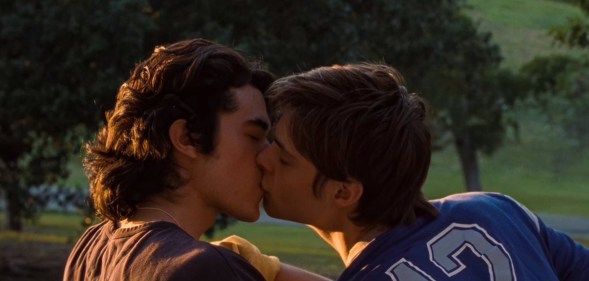 Conan Gray and Corey Fogelmanis kissing in "This Song" music video.