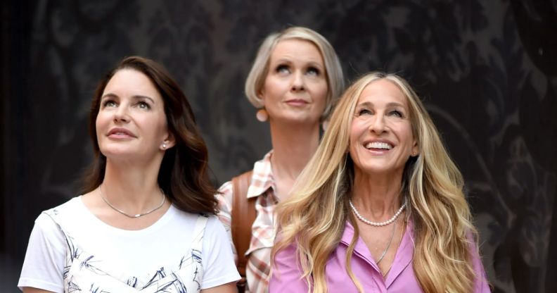 Kristin Davis, Cynthia Nixon and Sarah Jessica Parker look up as they are in character as Charlotte York Goldenblatt, Miranda Hobbes and Carrie Bradshaw.