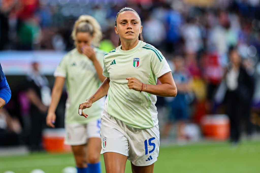 Annamaria Serturini of Italy jogging up the pitch.