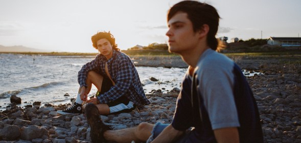 On a beach, Conan Gray looking fondly towards Corey Fogelmanis in Vodka Cranberry.