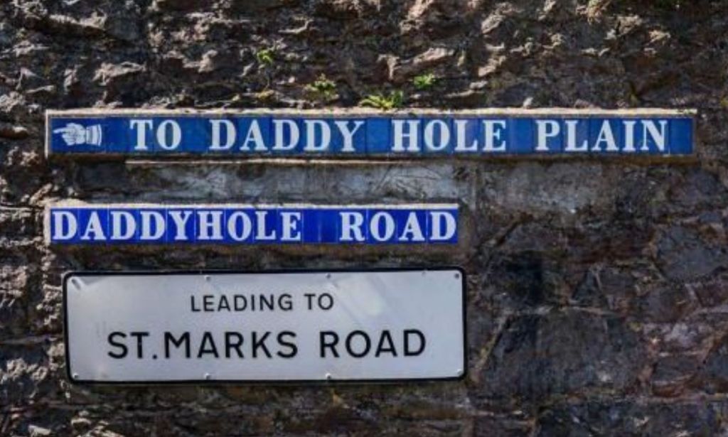 A set of signs leading off of Daddyhole Road.