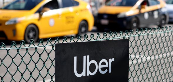 An image of two yellow taxi cabs with the uber logo in the foreground