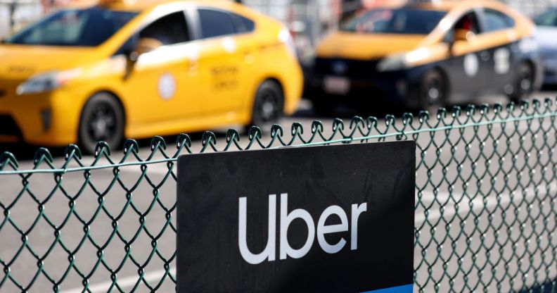 An image of two yellow taxi cabs with the uber logo in the foreground