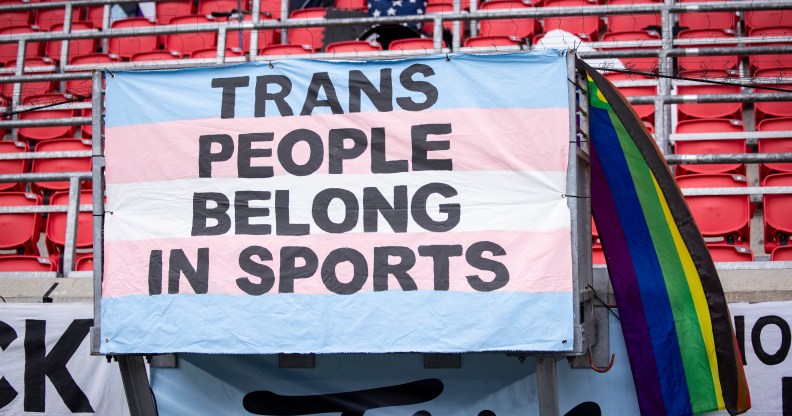 "Trans people belong in sports" banner.