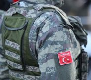 The side of a person in Turkish military fatigues.
